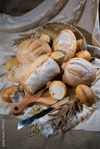 Different kinds of bread and pastry on canvas background