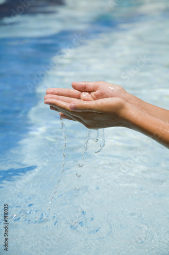 Clearfresh water falling from hands photo