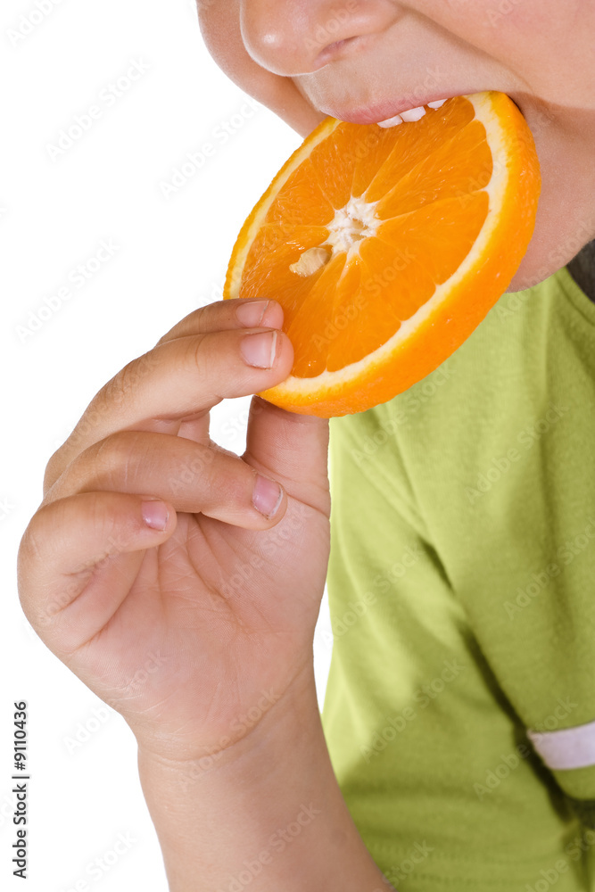 Closeup of boy eating orange slice - isolated Closeup of boy eating orange slice - isolated