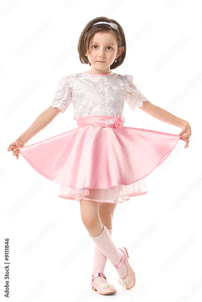 The lovely little girl posing in a beautiful pink dress The lovely little girl posing in a beautiful pink dress