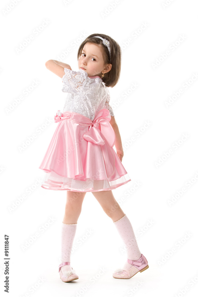The lovely little girl posing in a beautiful pink dress. The lovely little girl posing in a beautiful pink dress.