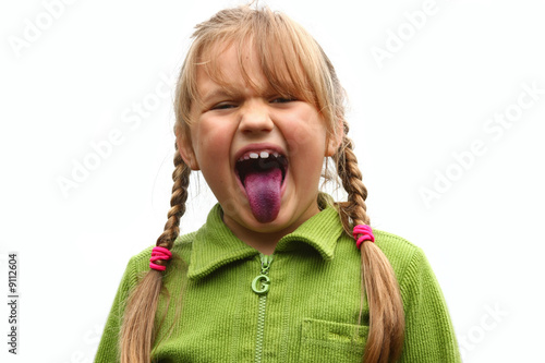 Girl showing her tongue after eating bilberries