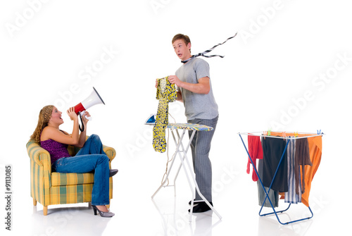 Young bossy woman shouting with megaphone to husband