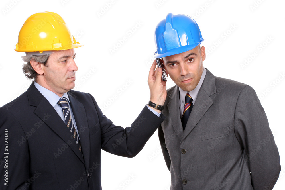 Two Engineers or Architects, on the phone, isolated in white Two Engineers or Architects, on the phone, isolated in white