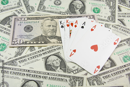 Dollar banknotes and full house holdem poker cards