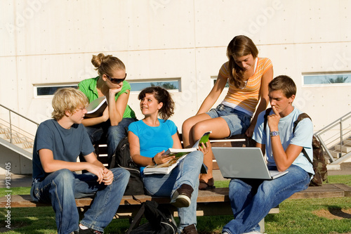 college kids or students talking with laptop