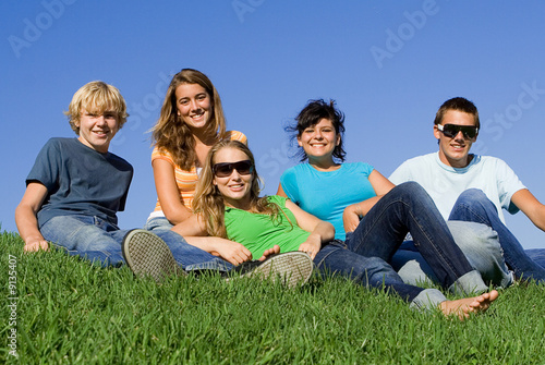 group of youth relaxing outdoors © godfer
