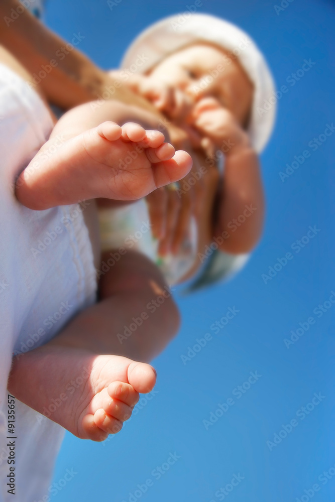 baby on parent's hands, focus on feet baby on parent's hands, focus on feet