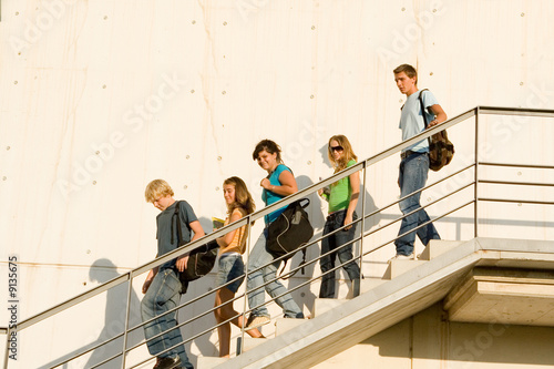 school or college students walking down stairs