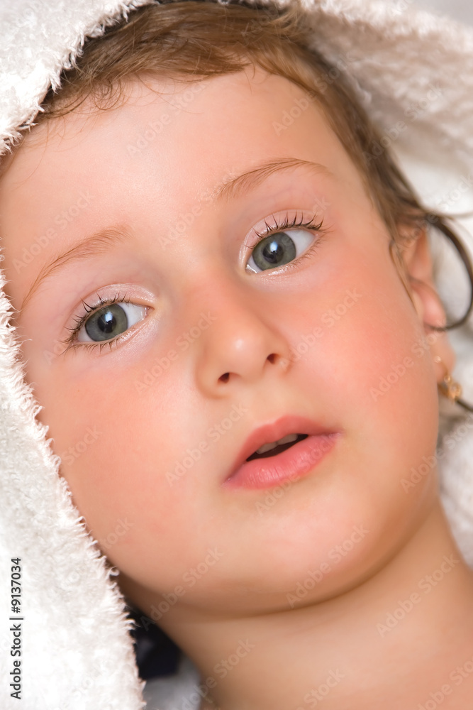 Young baby girl wrapped up in a bath towel.