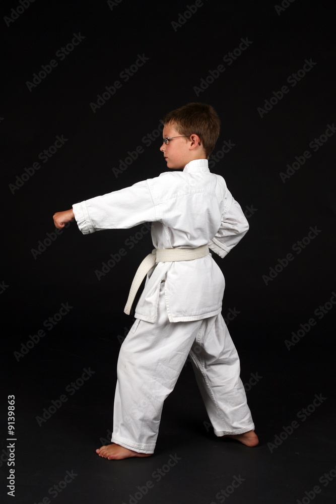 young boy demonstrating left stance with a punch