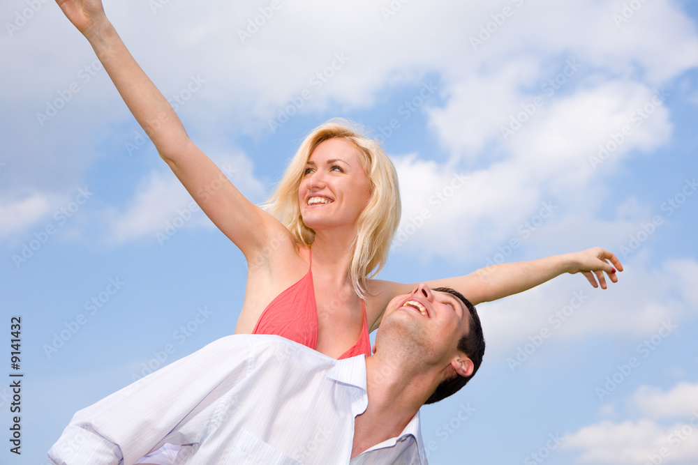 Young love Couple smiling under blue sky Young love Couple smiling under blue sky