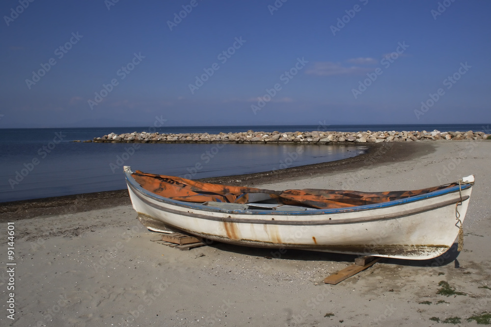 an old boat on a sand beach