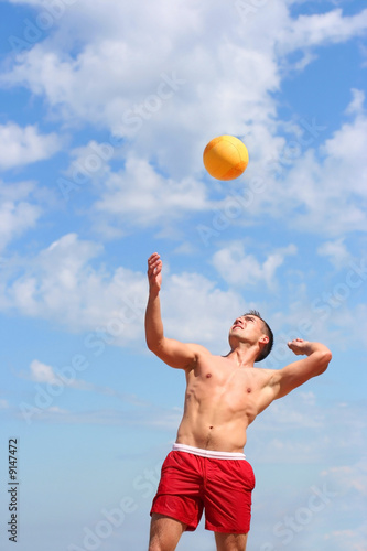 athletic guy playing volley-ball on the beach © Foxy_A