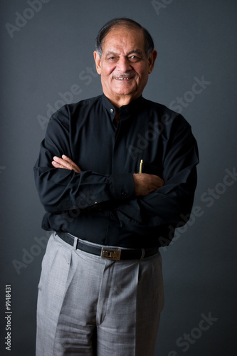 Portrait of a happy elderly East Indian businessman