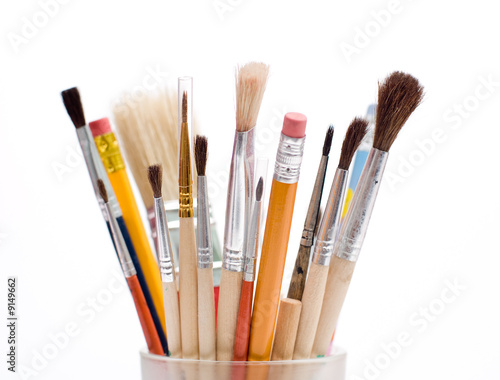 Pencils and brushes closeup at white background