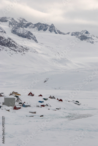 A small inuit village lost in a snowy landscape