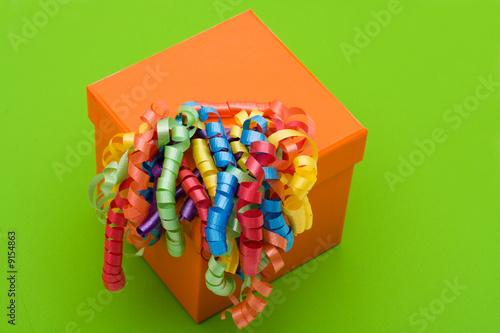 Wallpaper Mural Orange gift with ribbons on green background with copy space Torontodigital.ca