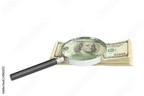 Magnifying glass on money background, business concept