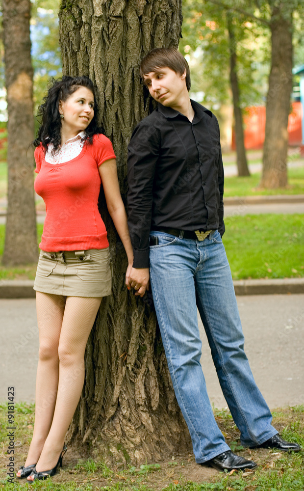 happy young couple near the tree happy young couple near the tree