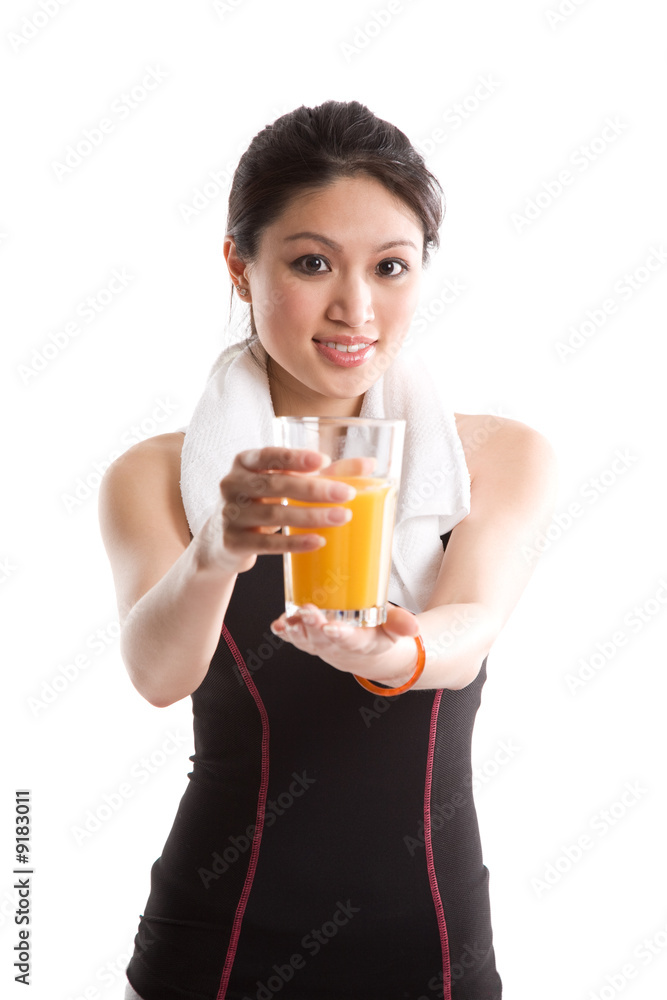 A healthy asian girl holding a glass of orange juice A healthy asian girl holding a glass of orange juice