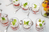 Sliced strawberries with cream and mint in glasses