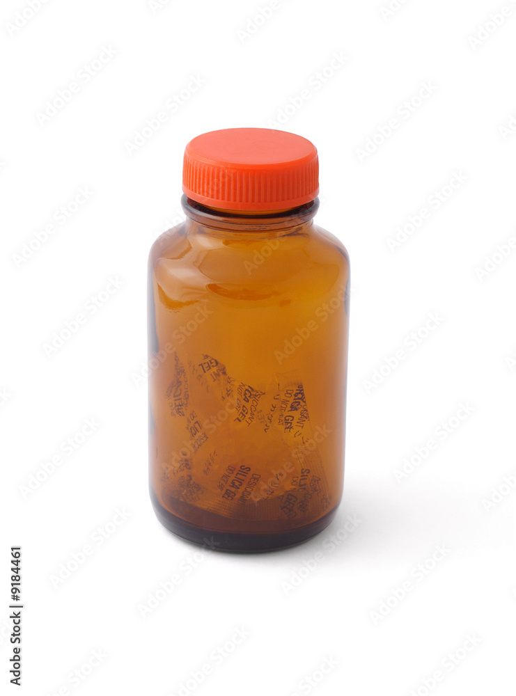 Empty glass bottle left with silica gel inside Empty glass bottle left with silica gel inside