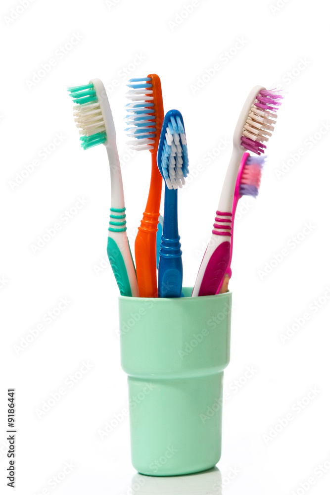Tooth brushes in glass on a white background Tooth brushes in glass on a white background