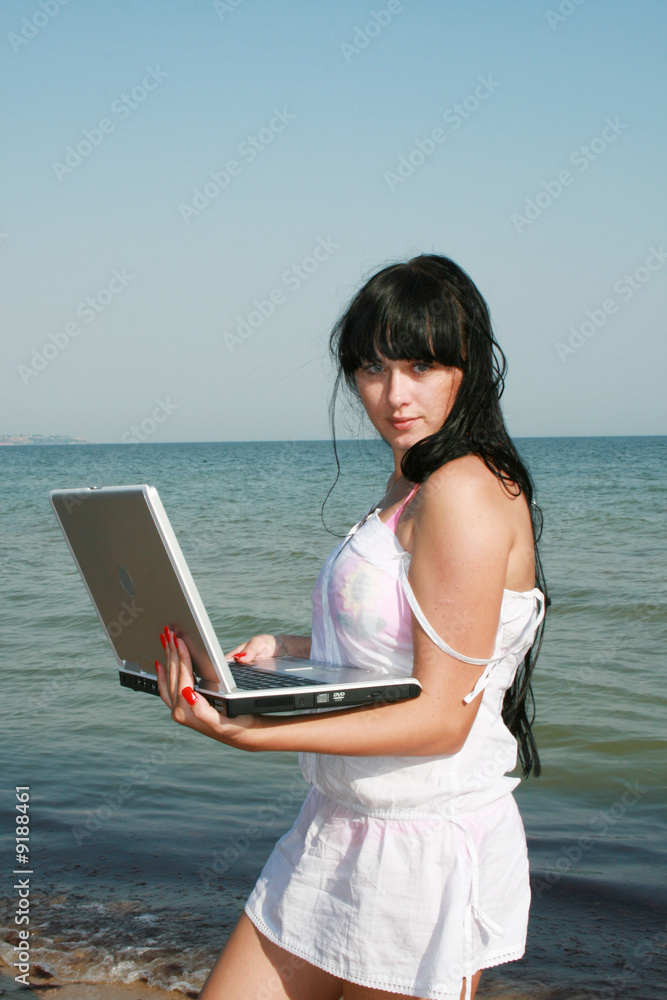 Girl on a beach with a notebook
