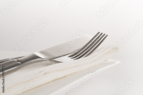 close up view of fork knife and napkin resting on plate