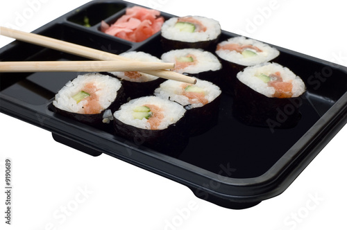 Rolls of sushi on a plate with chopsticks.