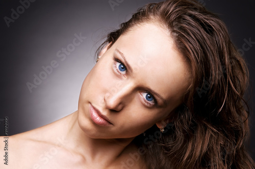 portrait of woman with blue eyes over dark background