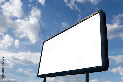 Blank advertisement board with cloudy blue sky photo