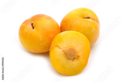 slice fresh yellow plum on white background
