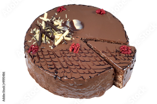Cut birthday cake with walnuts and decoration on white