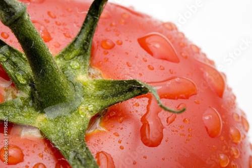Macro of a wet, ripe tomato. Studio shot.