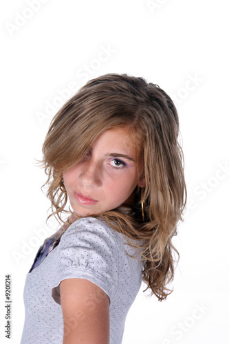 фотографія tween girl standing sideways and looking into camera