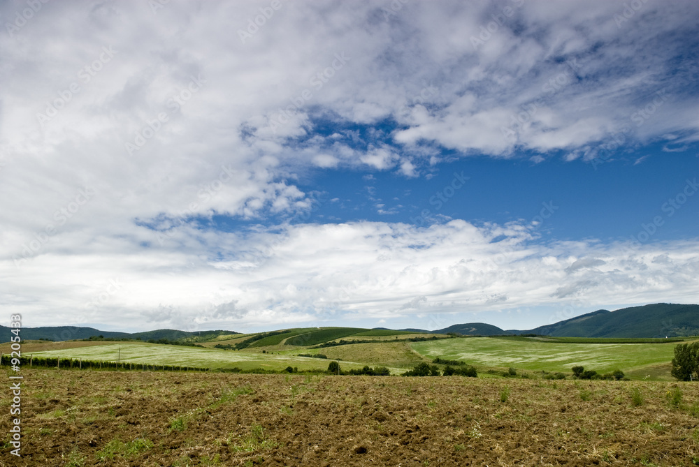 Hungarian rustic landscape with hills and many clouds