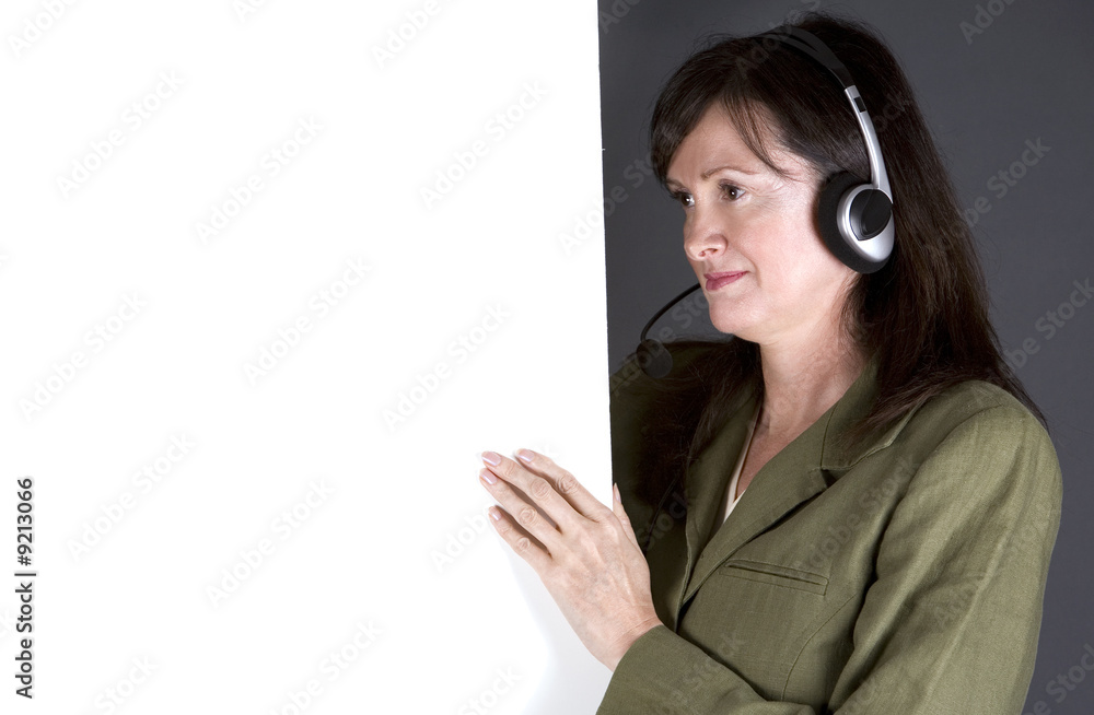 brunette with headset and board on the grey background brunette with headset and board on the grey background