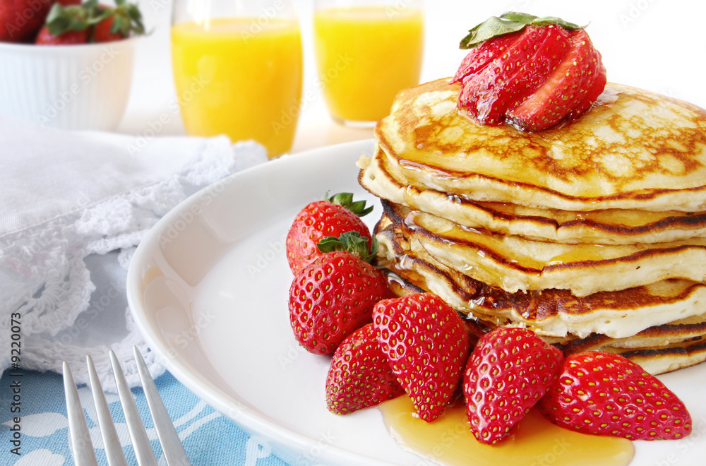 Stack of panckes with strawberries and maple syrup. Stack of panckes with strawberries and maple syrup.