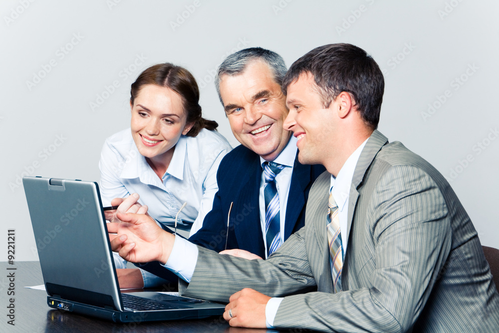 Portrait of smiling people discussing a computer work Portrait of smiling people discussing a computer work