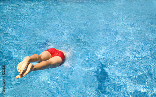 girl jumping into pool^