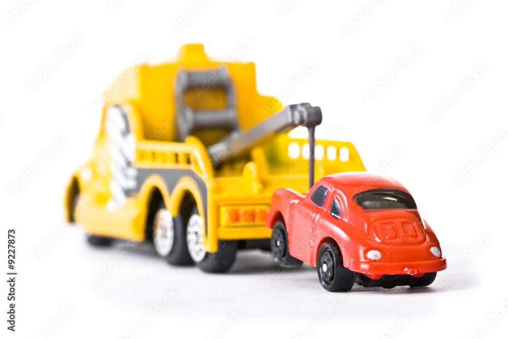 Red car being towed away by yellow tow truck (1) Red car being towed away by yellow tow truck (1)