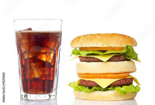 Cheeseburger and soda glass, reflected on white background