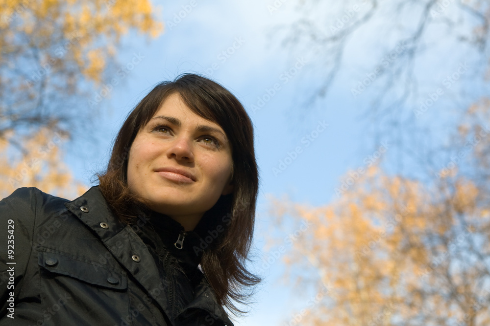 Young beautiful woman dreaming of something at autumn park Young beautiful woman dreaming of something at autumn park