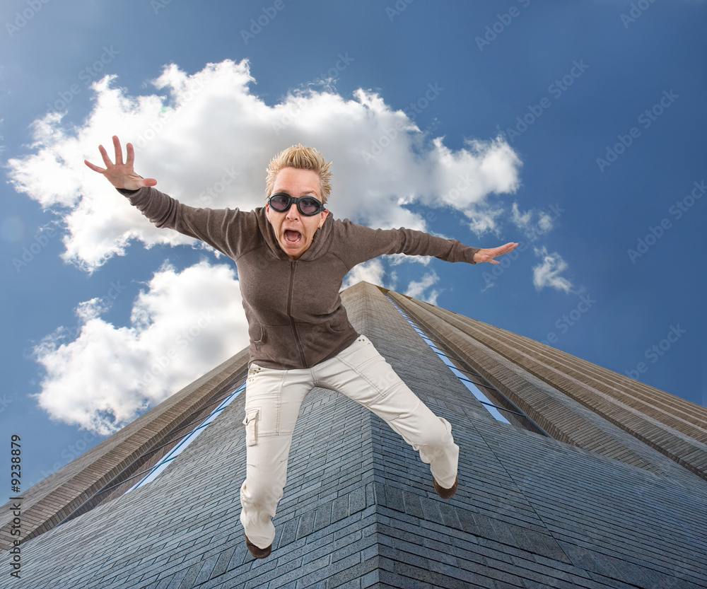 a woman falling off of a tall building Stock Photo