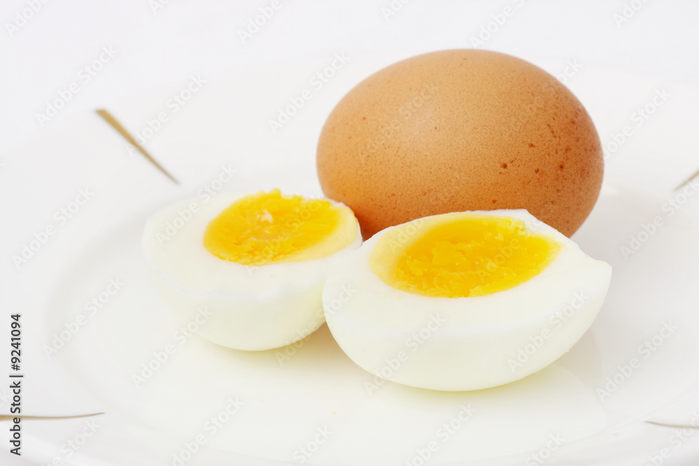 Cooked egg slieced into half put together with raw egg. Cooked egg slieced into half put together with raw egg.