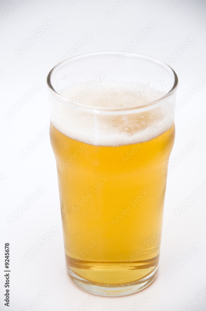 A pint of beer isolated on a white background A pint of beer isolated on a white background