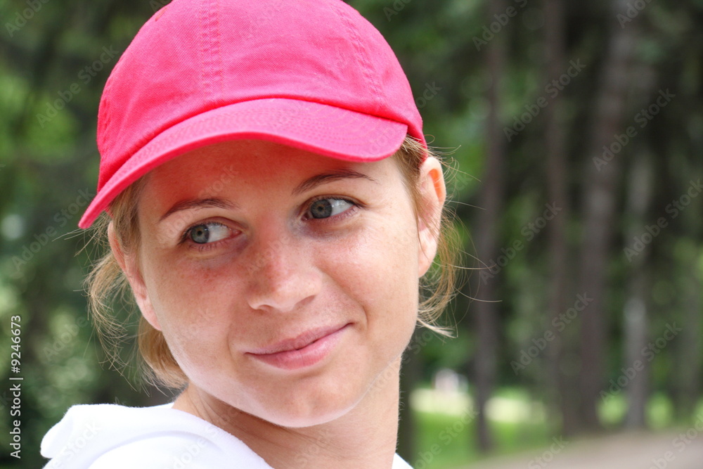 Portrait of smiling young woman in a red cap Portrait of smiling young woman in a red cap