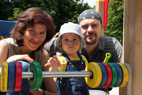 A family with a little girl who stretches her hand